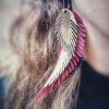 Light red earrings in the shape of angel wings